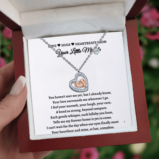 Imagine her reaction receiving this heartfelt symbol of love, family, and precious beginnings. The&nbsp;Baby Feet Heart Necklace features a sparkling heart-shaped frame adorned with shimmering cubic zirconia, surrounding a delicate pair of rose gold baby feet. A touching tribute to motherhood and new life, this necklace is the perfect way to celebrate a new mom, a cherished child, or a growing family.